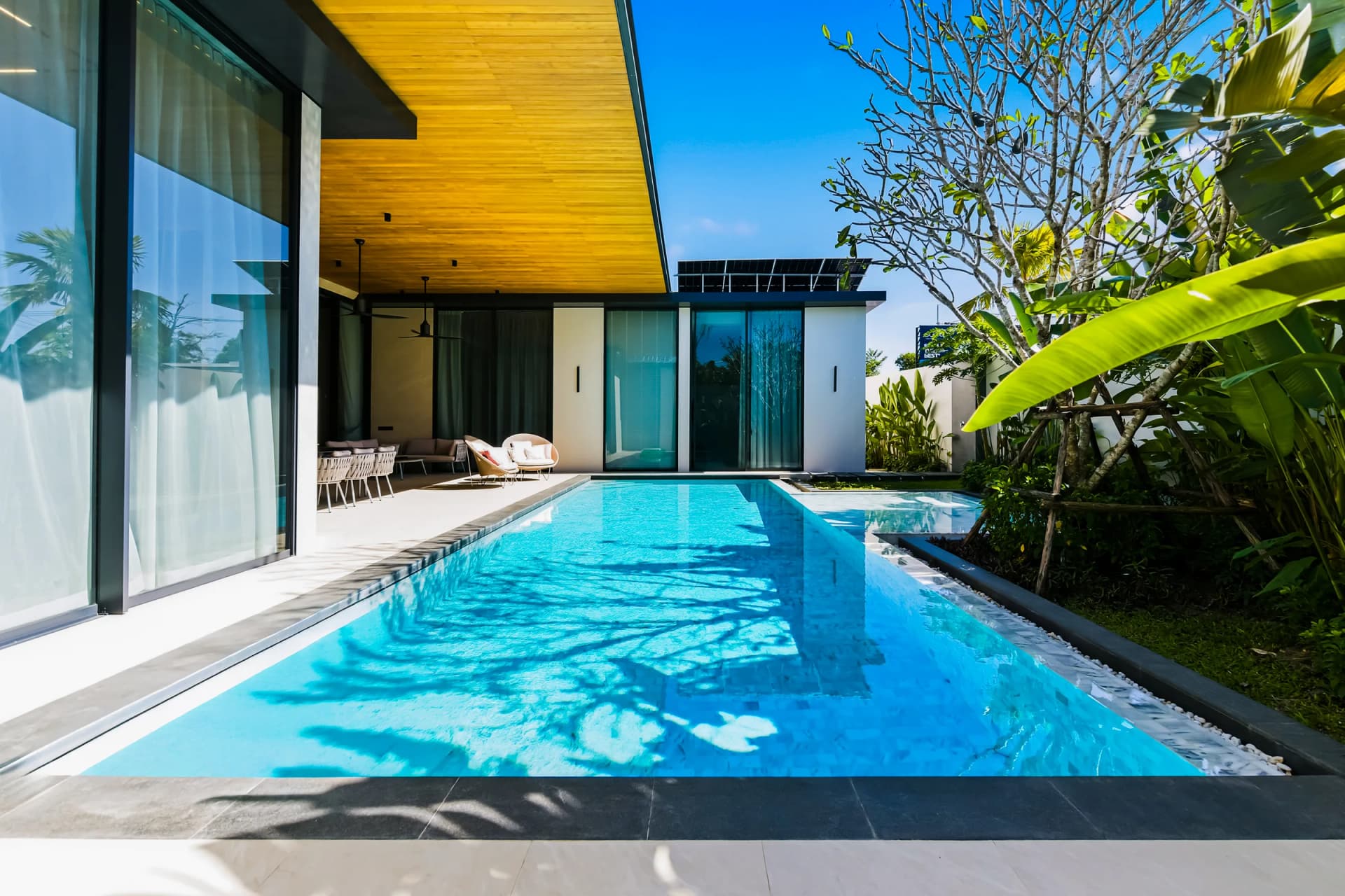 Villa 1: the long private pool beside the glass living wing